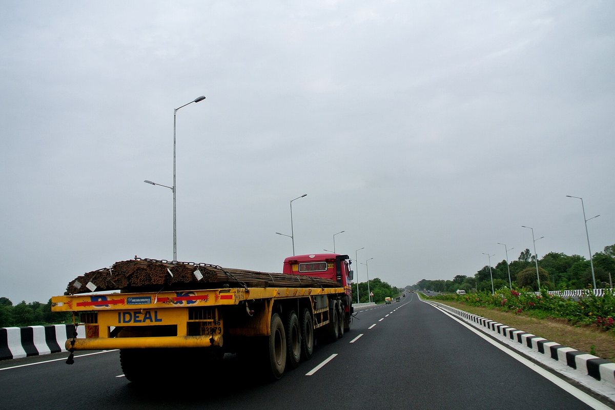 Flatbed truck carrying freight on a roadway